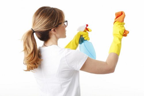 Homeowner vacuuming curtains for routine maintenance
